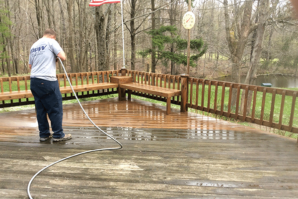 Hydro Savage Pressure Washing technician power washing a deck