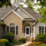 Picture of a brick and vinyl-sided home displaying the many common parts of a house exterior.