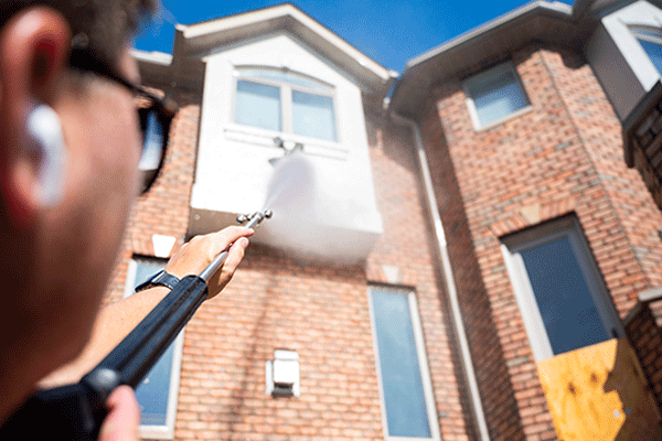 Power washing a brick house