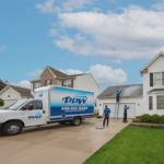 Hydro Savage Pressure Washing technicians cleaning a roof, driveway, and house