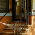 The Hydro Savage Pressure Washing Dream Team visits Malachi House. A power washing technician is washing the front of the building with safe pressure.