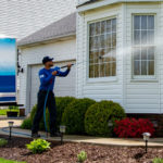 Image of Hydro Savage Pressure Washing power washing a white sided house