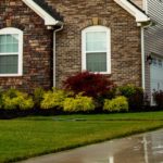 The most common types of concrete sealer are penetrating and topcoat sealers. Here, a power washing technician is applying a penetrating siloxane-silane sealer to a concrete driveway.